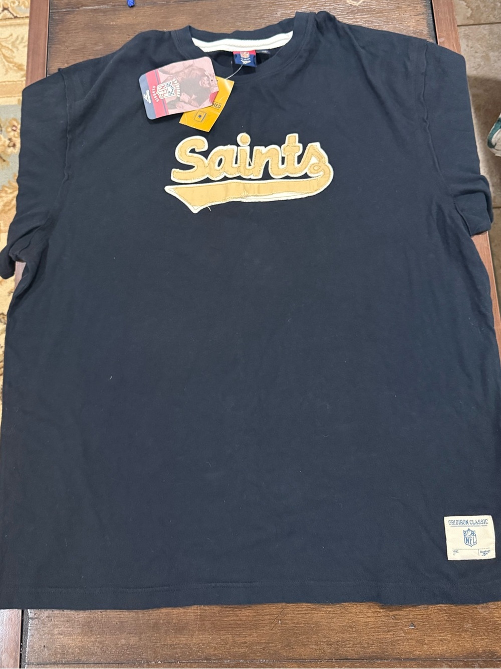 Reebok Black Tee with Gold Saints Script Logo